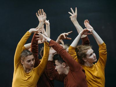 Blurry motion of a person performing rhythmic arm movements.